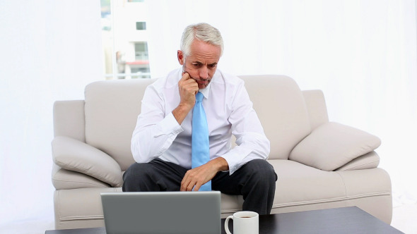 Stressed Businessman Looking At Laptop Then Camera