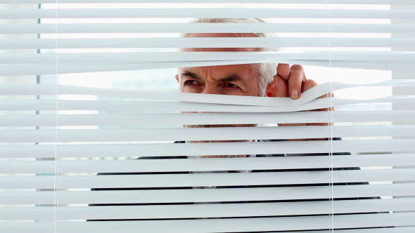 Businessman Spying Through Blinds 3