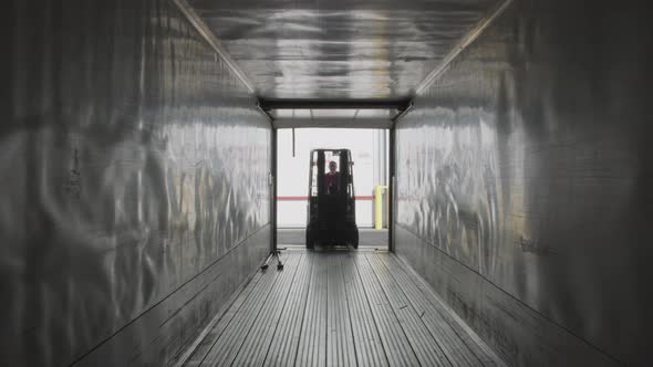 Forklift driving into semi truck trailer.  Fully released for commercial use.