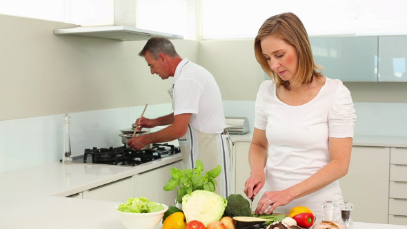Mature Happy Couple Making Healthy Dinner Together