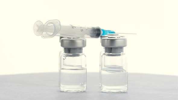 Syringes and Vials of Vaccine From the Virus Covid 19 alt