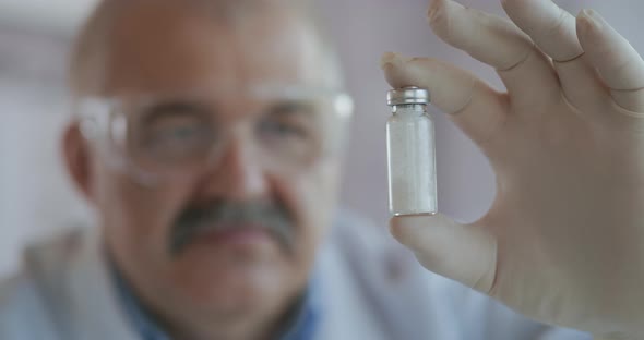 A Pharmacist Holds a Medicine with White Powder in Ampoules Made of Glass. A New Drug To Fight alt
