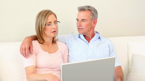 Mature Couple Looking At Laptop Together