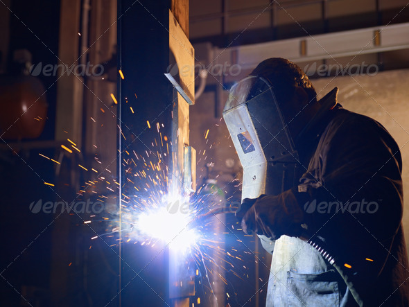 Man at work as welder in heavy industry - Stock Photo - Images