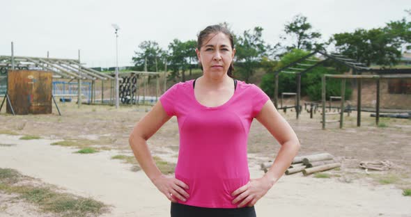 Caucasian woman looking at camera at boot camp alt