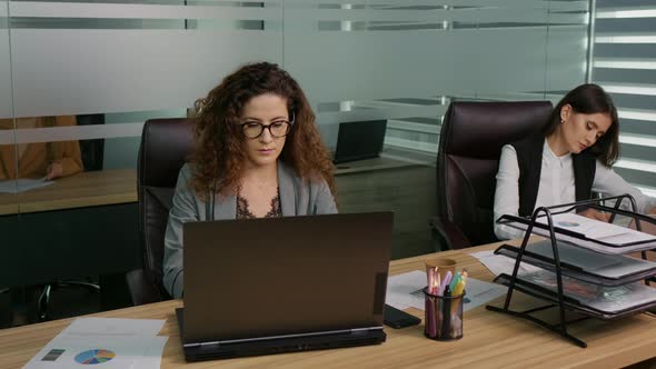 Business owners absorbed in accomplishing tasks growing business. alt