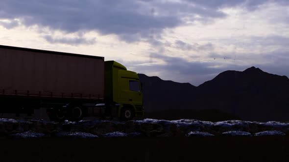 Freight Truck Moving On Rocky Path In Rainy Mountainous Evening