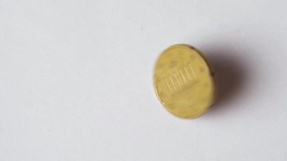 Close-up of a metal coin rotating in slow motion. A coin of twenty euro cents. The concept of econom alt
