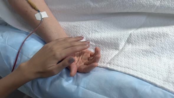 Relative Holding Ill Woman by Hand in Hospital Ward, Support in Sickness