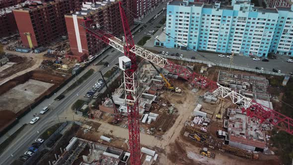 Aerial drone footage flying over construction crane.