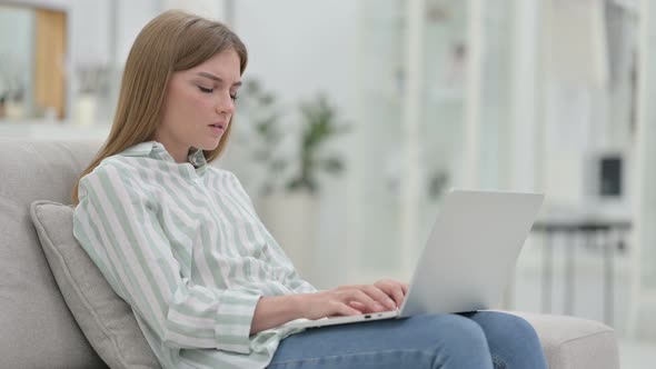 Tired Young Woman with Laptop Having Back Pain at Home  alt