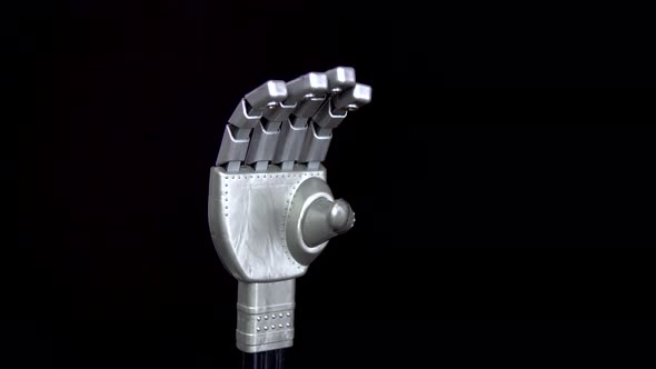 A Mechanical Arm Flexes Fingers. Gray Cyborg Arm Came To Life and Began To Move on a Black alt