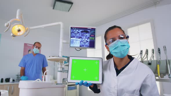 Patient Pov of Dentist Analisyng Xray Using Tablet with Green Screen alt