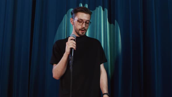 Guy Comedian Wearing Eyeglasses Performing His Stand Up Show