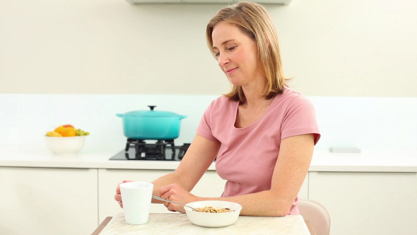 Mature Woman Having Coffee At Breakfast alt
