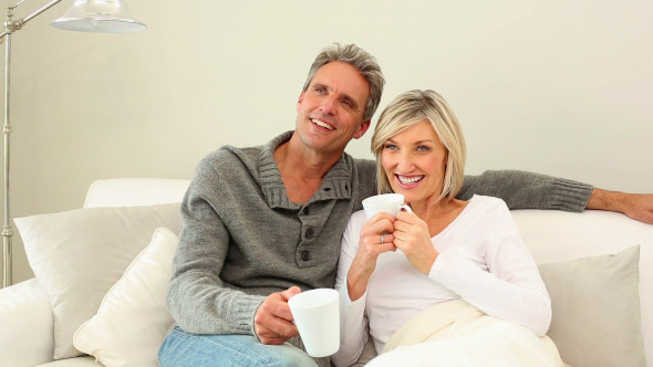 Couple Drinking Coffee On The Couch 1