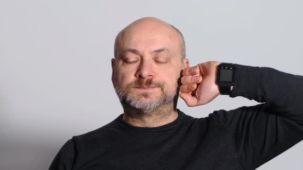 funny mature man untaps ears with little finger. Hearing, cleaning- slow motion alt