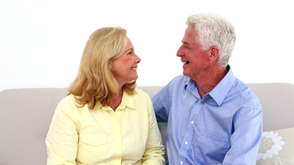 Smiling Retired Couple Being Affectionate
