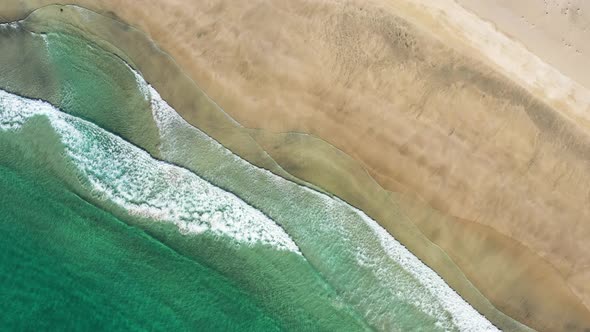 Top down view on the Lofoten beach and sea waves
