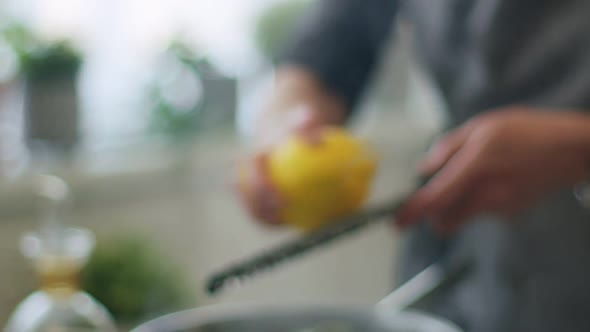 Woman adding lemon zest to stewing ossobuco alt