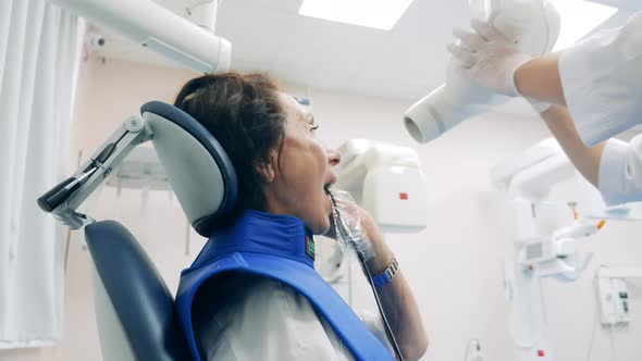 Female Patient is Expecting Dental Hygienic Procedure to Start alt