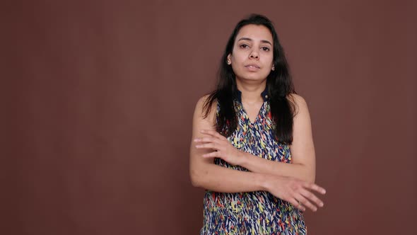 Portrait of Female Model Standing with Arms Crossed in Studio alt