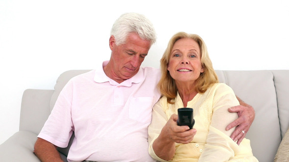 Retired Couple Watching Television On The Couch 2 alt