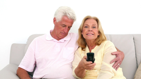 Retired Couple Watching Television On The Couch 2