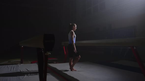 Young Athletic Woman is Training in Gymnastic Hall at Evening Gymnast Girl is Approaching to Balance alt
