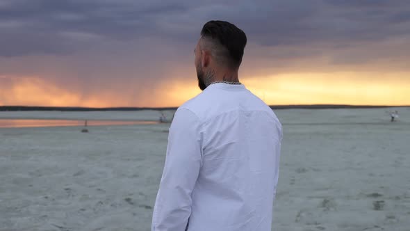 Brutal Man Walking on Beach