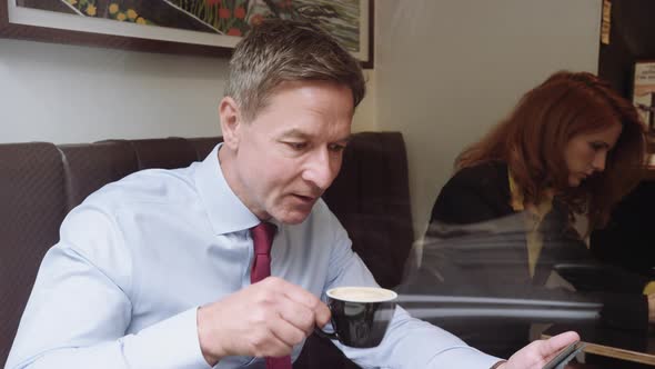 Businessman using digital tablet in cafe