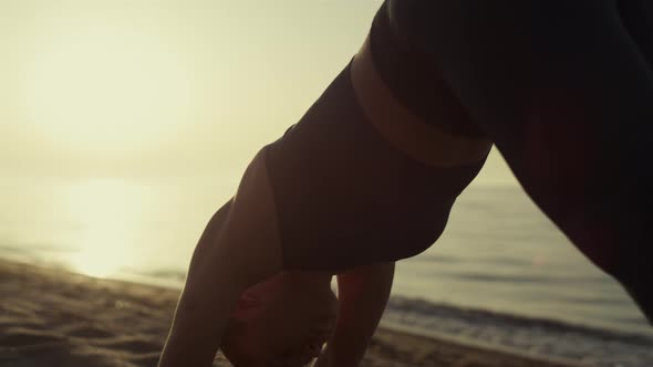 Fit Sportswoman Bending Body Standing Yoga Asana on Sandy Beach Close Up alt