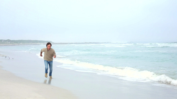 Happy Man Running Towards Camera On The Beach