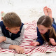 Siblings Lying On Blanket On The Beach Talking - VideoHive Item for Sale