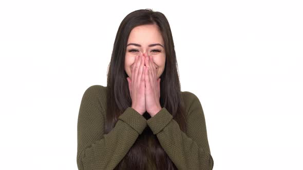 Portrait of Young Smiling Woman 20s Expressing Happiness and Surprise Covering Open Mouth with alt