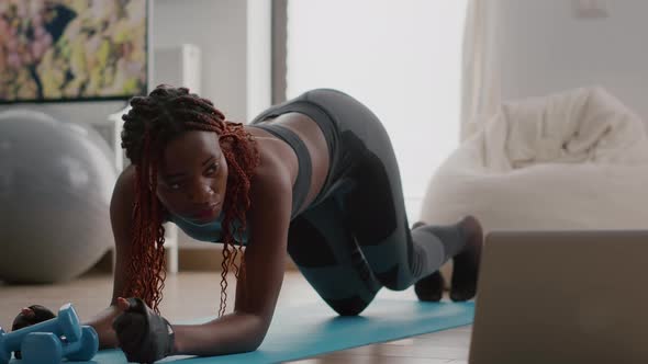 Afro American Woman with Sportswear Stretching Yoga Exercises on Fitness Map alt