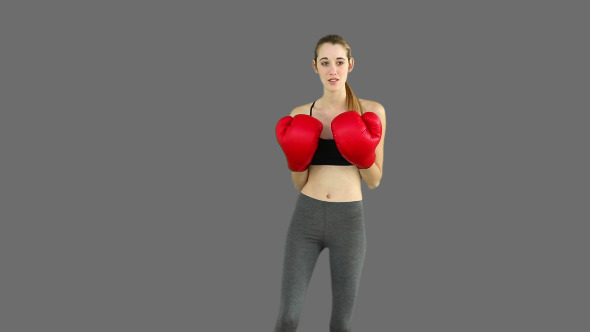 Fit Model Punching With Red Boxing Gloves 2