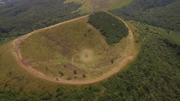 Aerial travel drone view of the Puy de Dome, lava dome volcano in France. alt