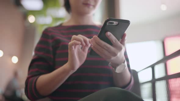 Close up shot asian woman using smartphone in cafe