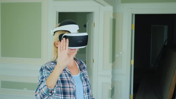 Female Interior Designer Looks at Project in Virtual Reality Helmet alt