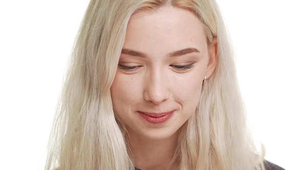 Close Up Footage in Slowmotion of Beautiful Shy Smiling Blonde Caucasian Teenage Girl alt