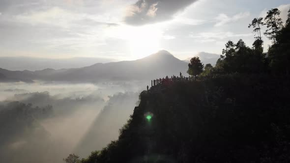 Aerial view of Beautiful Sunrise Behind A Mountain Overlooking a Foggy Valley