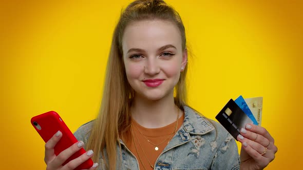 Teen Girl Using Credit Bank Cards and Smartphone While Transferring Money Purchases Online Shopping alt