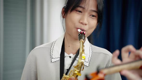 Close-up saxophone,Asian woman who is a member of a classical band