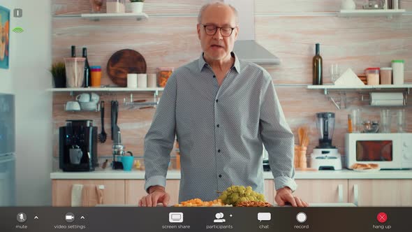 Senior Man Having Video Call in Kitchen alt