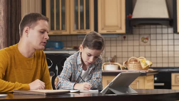 Man helping his son to do homework