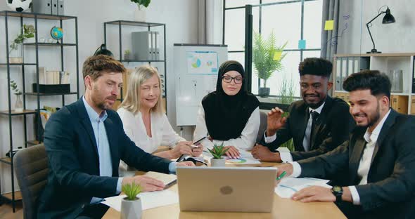 Businesspeople Holding Online Conference with Partners Via Laptop and Discussing Joint Project alt