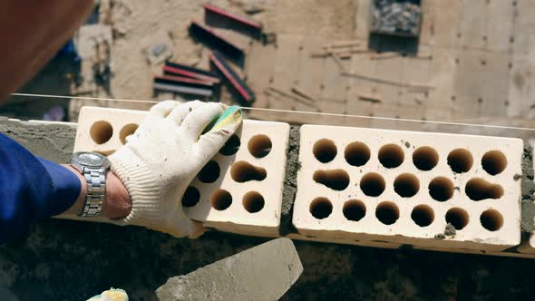 Bricks with Concrete Are Getting Put Together alt