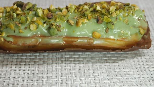 Dolly Shooting Pistachioflavored Custard Eclair with Pistachio Chunks with Cream