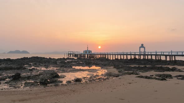 Timelapse The Small Pier Juts Out Into The Sea In Sunrise. alt